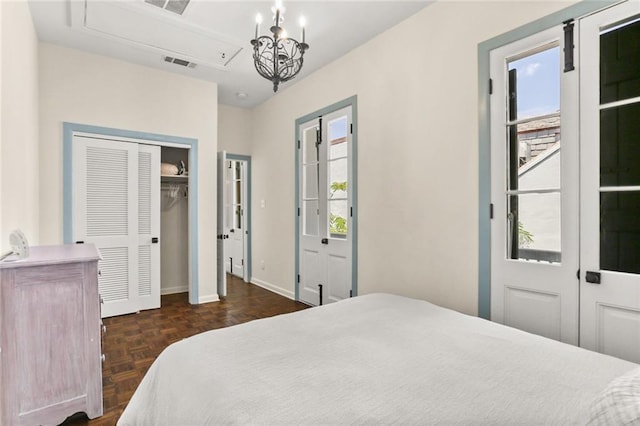 415 Burgundy St Unit 1B, New Orleans, LA 70112 - bedroom with baseboards, a chandelier, and attic access