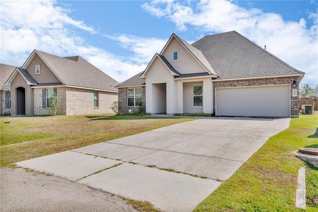 view of front of home featuring central AC unit, an attached garage, driveway, and a front lawn