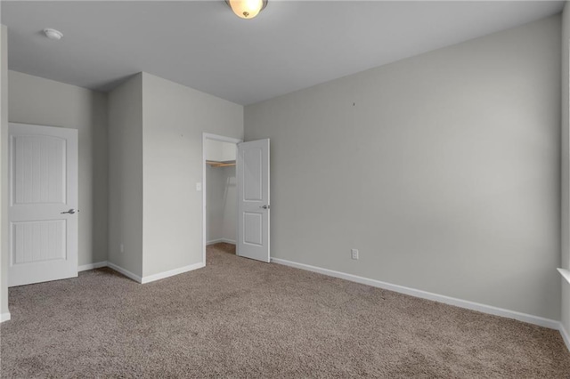 unfurnished bedroom with carpet floors, baseboards, and a closet