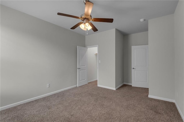 unfurnished bedroom featuring carpet, baseboards, and a ceiling fan