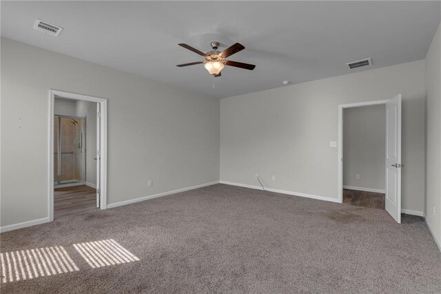 carpeted empty room with ceiling fan and baseboards