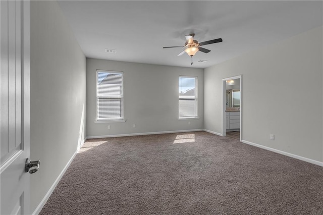 empty room with ceiling fan, carpet, and baseboards