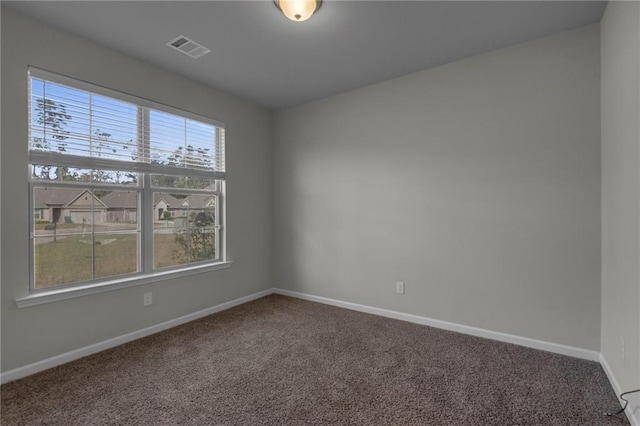 carpeted spare room with baseboards