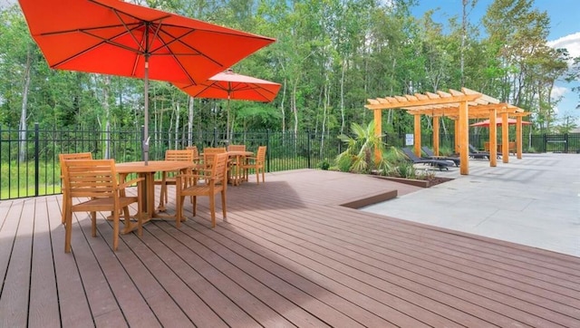 deck with a pergola, fence, and outdoor dining space