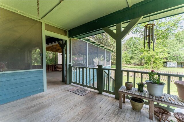 wooden terrace featuring a sunroom