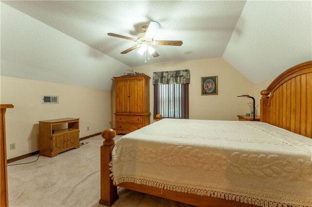 bedroom with visible vents, lofted ceiling, light carpet, baseboards, and a ceiling fan