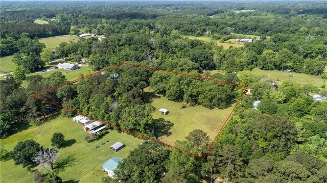 birds eye view of property featuring a wooded view