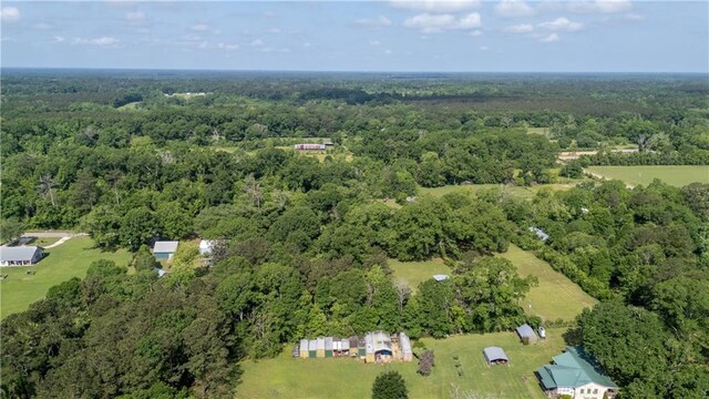 drone / aerial view with a wooded view