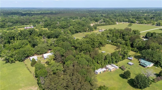 drone / aerial view featuring a wooded view