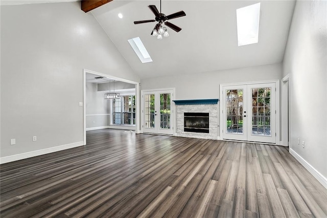 6024 Chateau Loire Cir, Mandeville, LA 70448 - unfurnished living room featuring beamed ceiling, ceiling fan, high vaulted ceiling, french doors, and a skylight