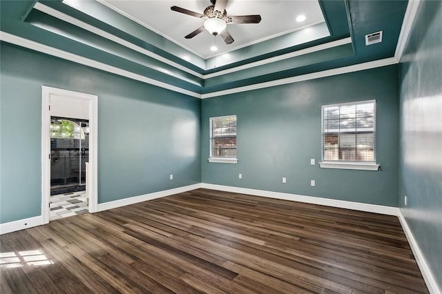 6024 Chateau Loire Cir, Mandeville, LA 70448 - spare room featuring a raised ceiling, ornamental molding, a ceiling fan, visible vents, and dark wood-style floors