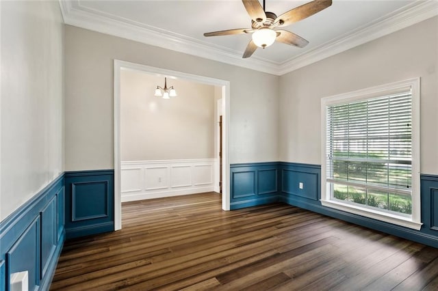 6024 Chateau Loire Cir, Mandeville, LA 70448 - empty room featuring a wainscoted wall, ornamental molding, ceiling fan with notable chandelier, and dark wood-style flooring