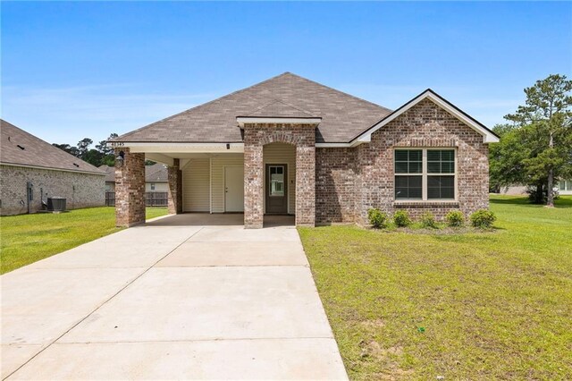 48345 Red Fox Dr, Hammond, LA 70401 - french country style house with brick siding, driveway, a front lawn, and a carport
