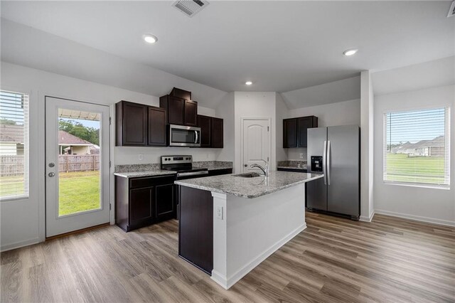 48345 Red Fox Dr, Hammond, LA 70401 - kitchen with stainless steel appliances, open floor plan, light wood-style flooring, dark brown cabinetry, and recessed lighting