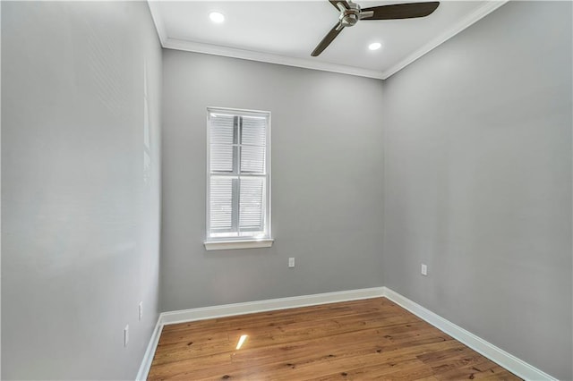 spare room with ceiling fan, wood finished floors, baseboards, ornamental molding, and recessed lighting