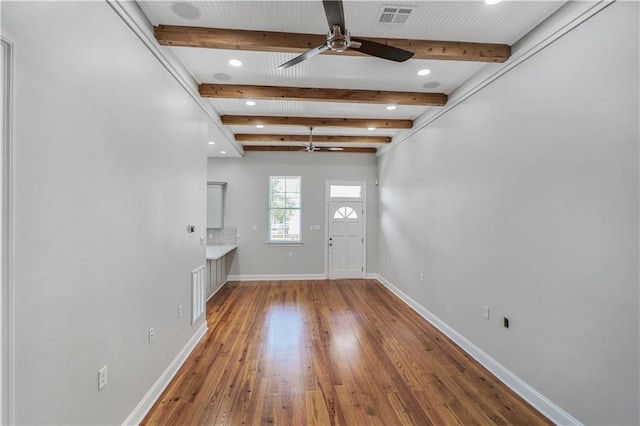 entrance foyer with a ceiling fan, baseboards, beamed ceiling, visible vents, and hardwood / wood-style flooring
