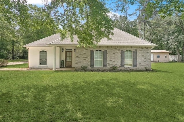 single story home with a shingled roof and a front yard