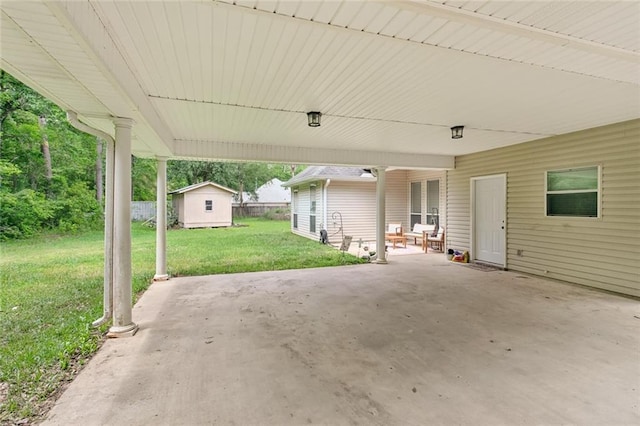 23284 Burvant St, Abita Springs, LA 70420 - view of patio featuring an attached carport, an outbuilding, and a storage unit