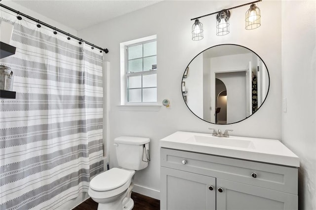 bathroom with wood finished floors, vanity, baseboards, toilet, and a shower with shower curtain