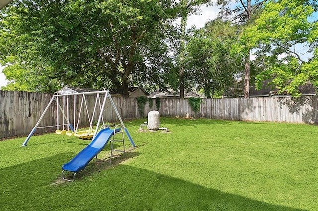 view of play area featuring a fenced backyard and a yard