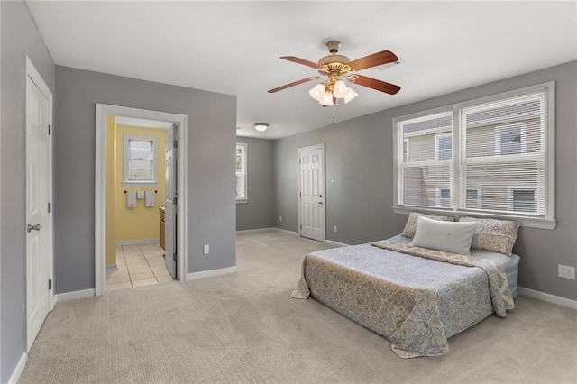 5652 General Haig St, New Orleans, LA 70124 - bedroom featuring connected bathroom, baseboards, light colored carpet, and ceiling fan