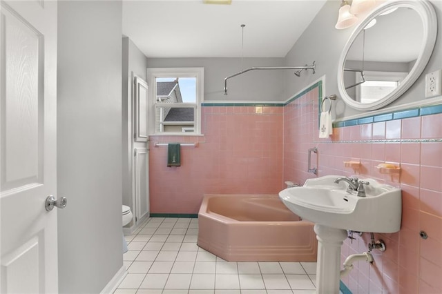 5652 General Haig St, New Orleans, LA 70124 - full bath featuring tile patterned flooring, walk in shower, a bath, and tile walls