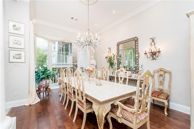 dining space with a chandelier, ornamental molding, baseboards, and wood finished floors
