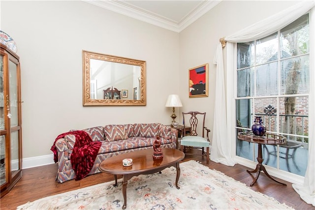 living room with crown molding, wood finished floors, and baseboards