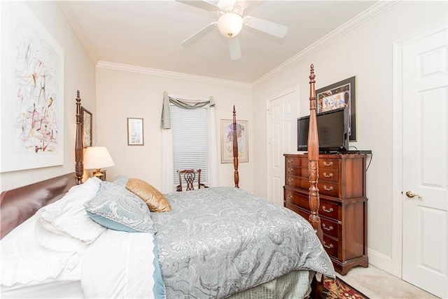 carpeted bedroom featuring ornamental molding and a ceiling fan