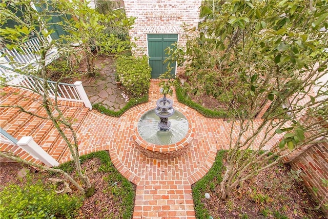 entrance to property with brick siding and a patio