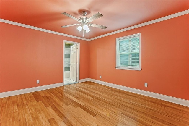 empty room featuring light wood-style floors, baseboards, ornamental molding, and a ceiling fan