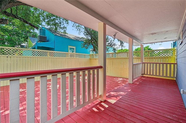 wooden terrace with fence and central air condition unit