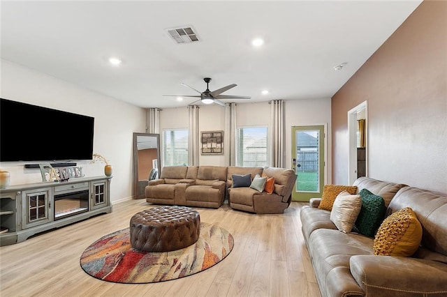 living area featuring visible vents, a ceiling fan, light wood finished floors, and recessed lighting