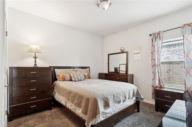bedroom featuring baseboards and carpet