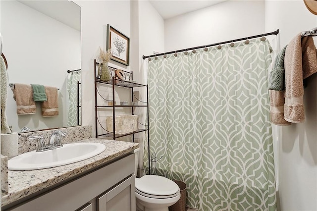 full bathroom with vanity, toilet, and curtained shower