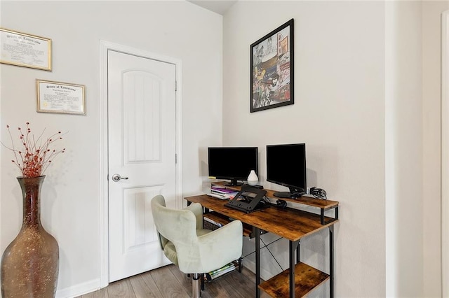 office area featuring baseboards and wood finished floors
