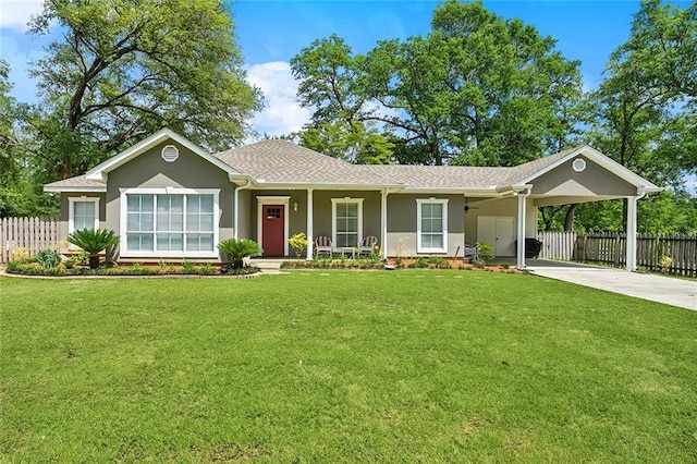 ranch-style house featuring fence, driveway, a front yard, and an attached carport