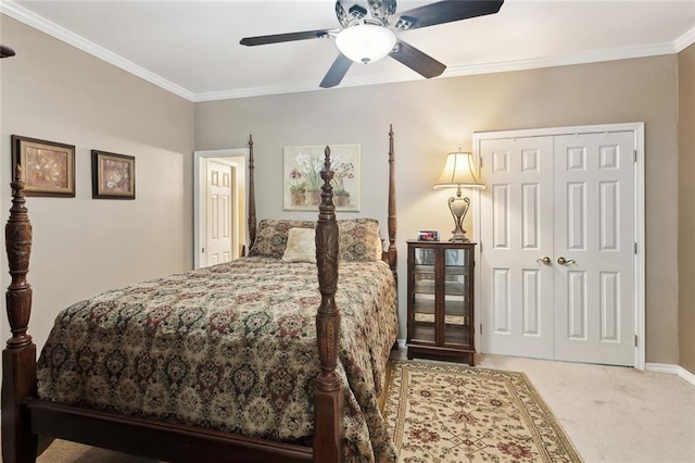 bedroom with a closet, ornamental molding, baseboards, ceiling fan, and carpet flooring