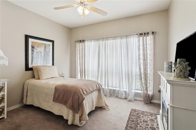 bedroom featuring baseboards, ceiling fan, and light colored carpet