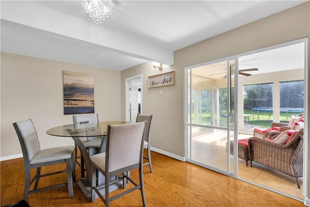 809 Oakwood Dr, Terrytown, LA 70056 - dining area featuring light wood-type flooring, baseboards, and ceiling fan with notable chandelier