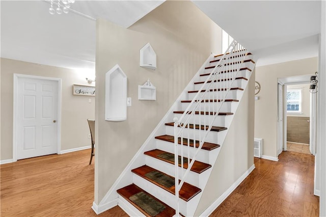 809 Oakwood Dr, Terrytown, LA 70056 - stairs with baseboards, wood finished floors, and visible vents