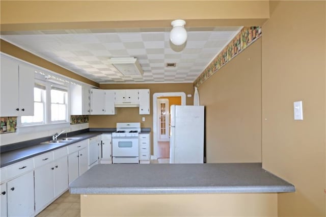 kitchen featuring dark countertops, white appliances, under cabinet range hood, white cabinets, and a sink