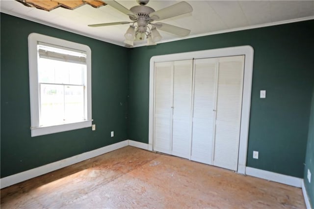 unfurnished bedroom with baseboards, multiple windows, and ornamental molding