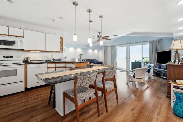 8004 Breakwater Dr, New Orleans, LA 70124 - kitchen featuring wood finished floors, white appliances, a breakfast bar, ceiling fan, and vaulted ceiling