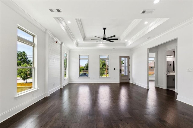 unfurnished living room featuring plenty of natural light, ceiling fan, dark wood-style floors, and visible vents
