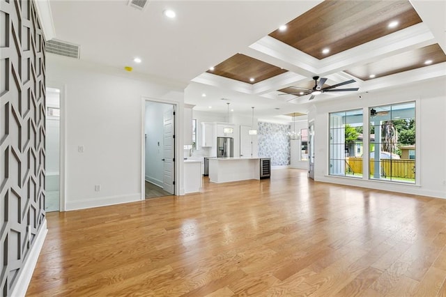 unfurnished living room featuring baseboards, ceiling fan, coffered ceiling, and recessed lighting
