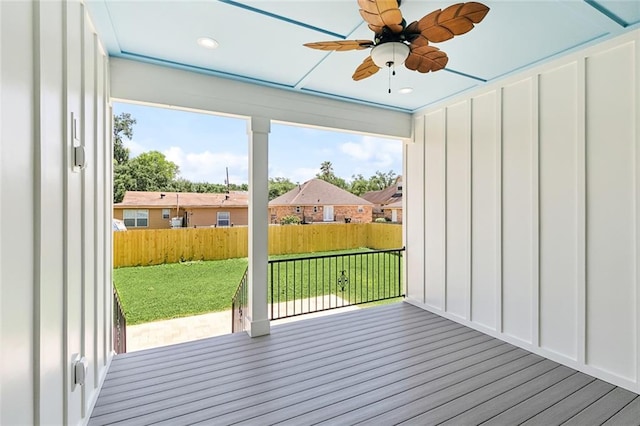 deck with a yard, ceiling fan, and a fenced backyard
