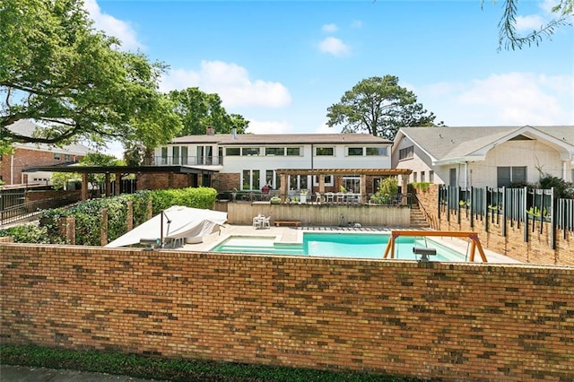 pool featuring fence, a patio, a diving board, and stairway