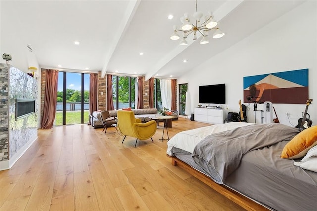 bedroom with access to outside, a chandelier, expansive windows, and light wood-type flooring