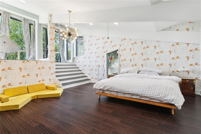bedroom with recessed lighting, wallpapered walls, a notable chandelier, and wood finished floors
